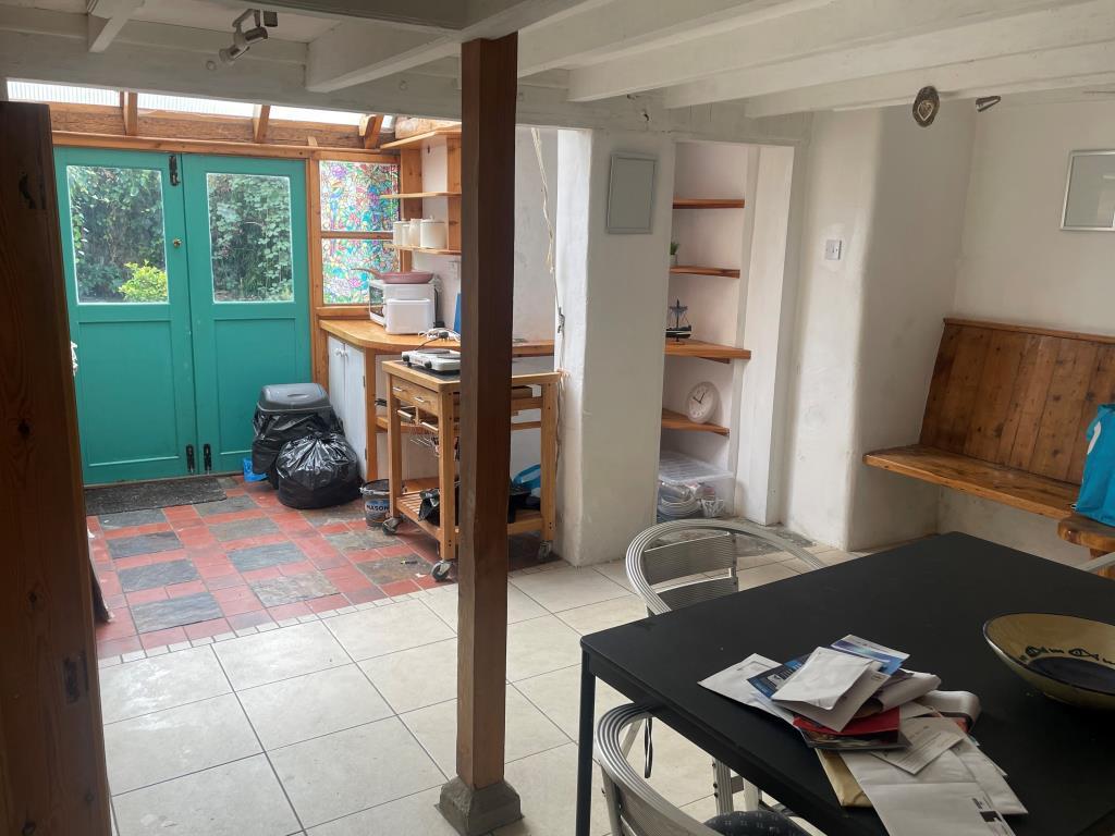 Kitchen with double doors leading to rear courtyar