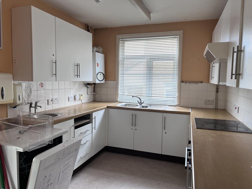 Kitchen with white fitted cupboards