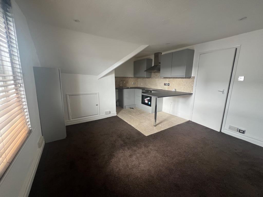 Open plan kitchen living room with white painted w