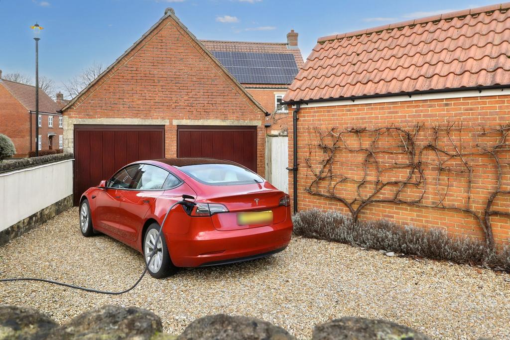 Double garage and gated driveway with ev charging