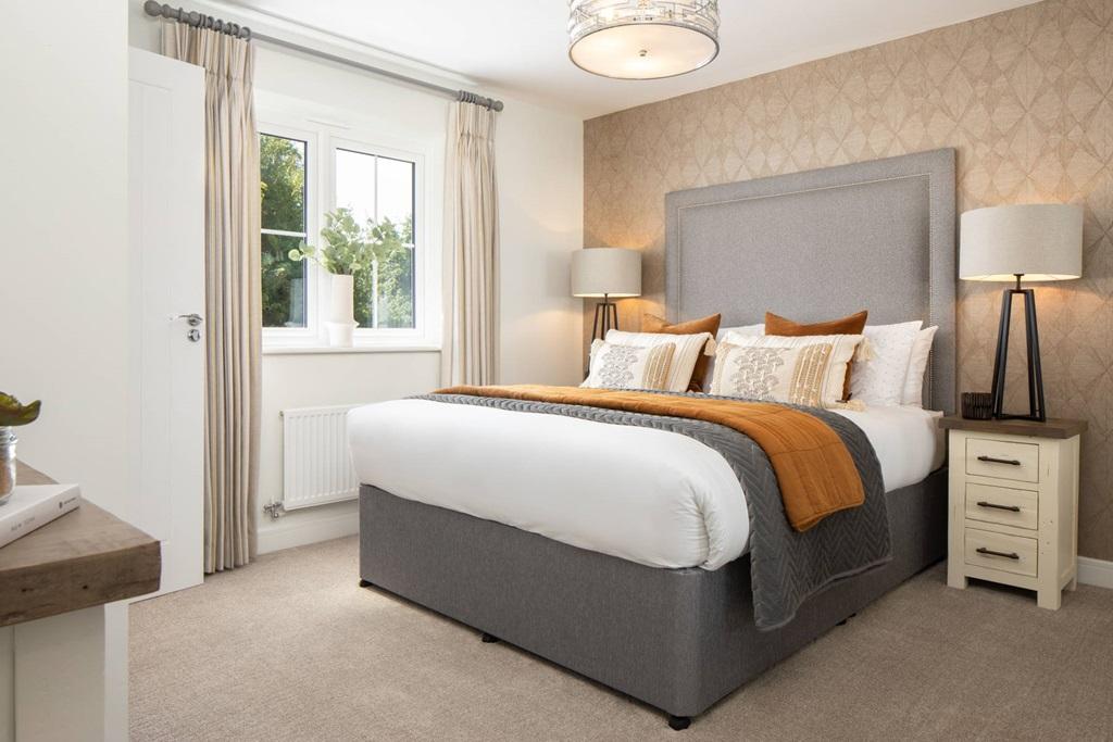 A spacious main bedroom has plenty of room for...