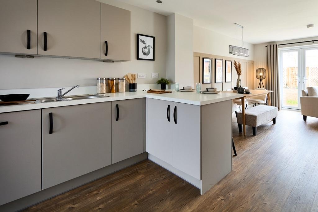 A useful breakfast bar joins the kitchen to the...