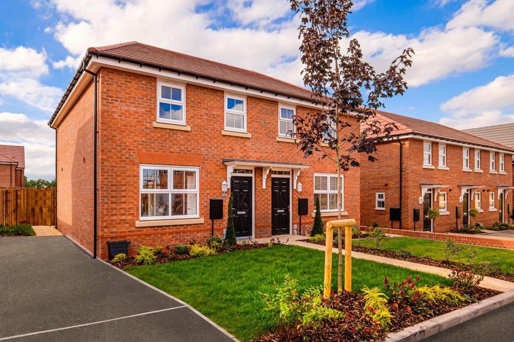 Semi detached red brick house with lawn