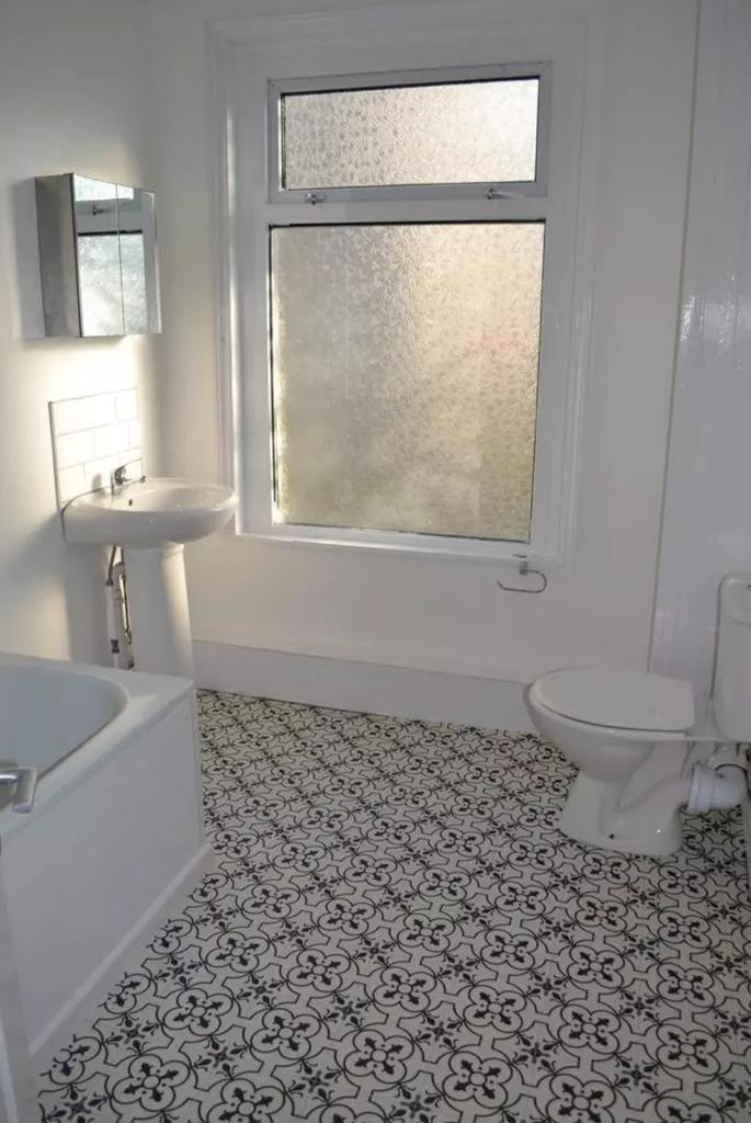 A bright and clean bathroom featuring a stylish...