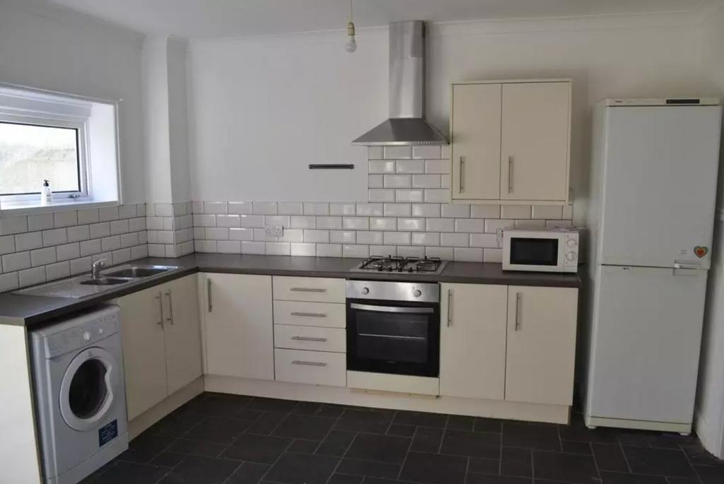 A modern and tidy kitchen featuring essential a...