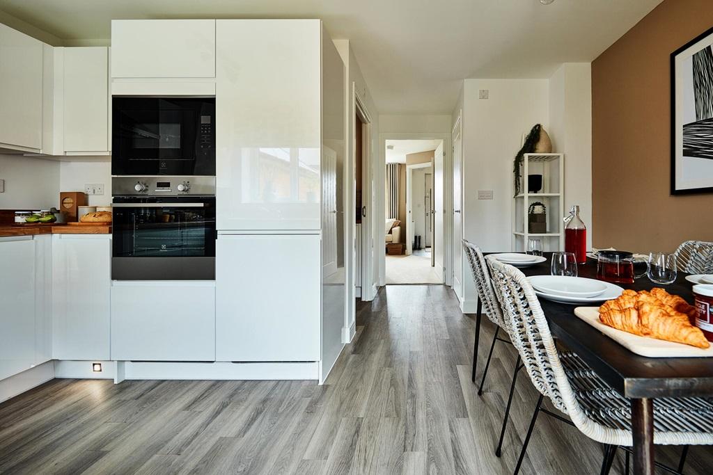 A bright and airy kitchen leads from through...