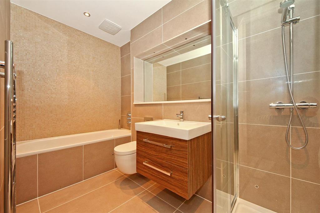 Sandstone tiled family bathroom