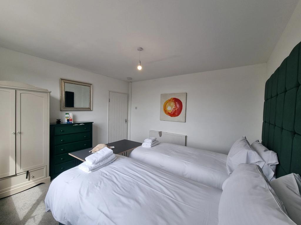 A spacious and well lit double bedroom featurin...