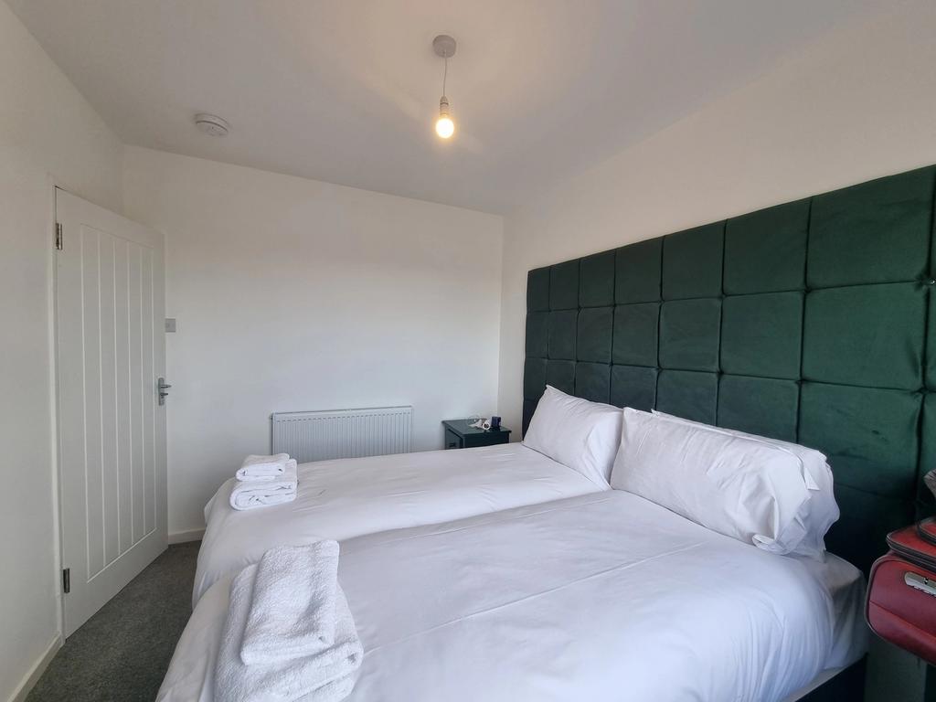 A bright and modern double bedroom, featuring a...