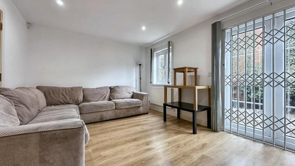 A clean and bright living room with a cozy sofa...