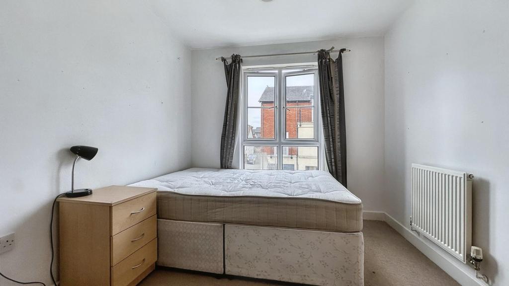 A tidy double bedroom featuring a bed, bedside ...
