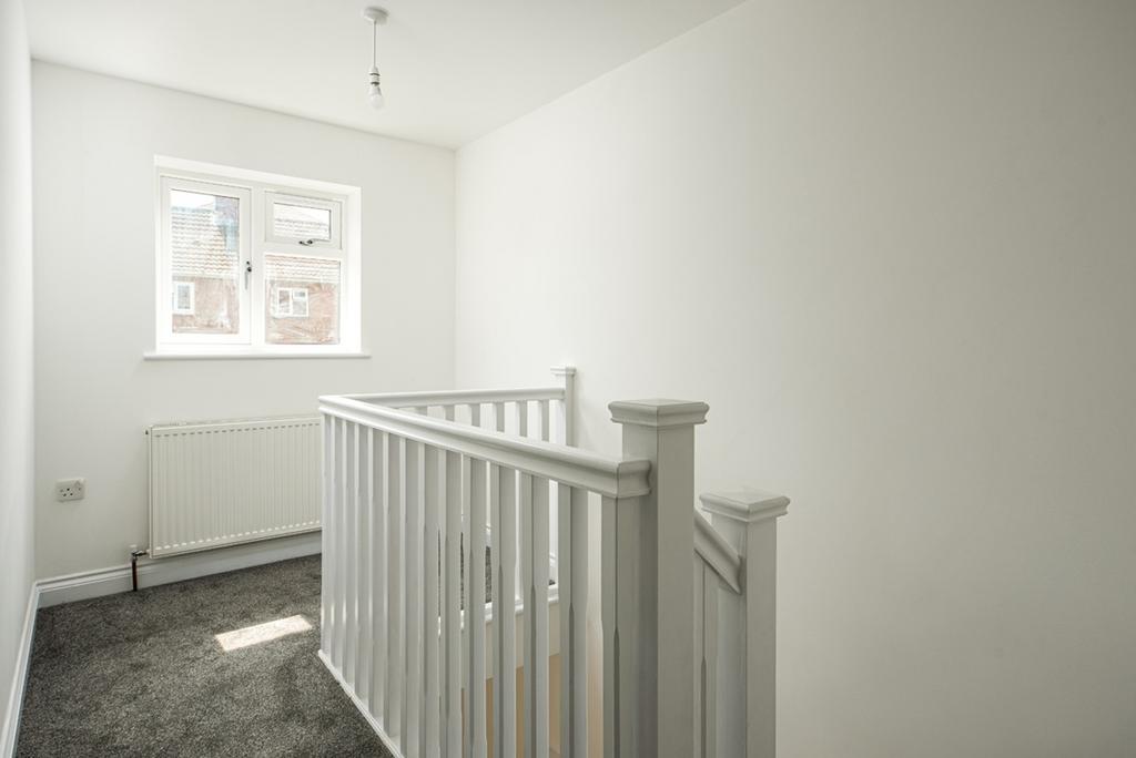 A clean and well-lit hallway with natural light...