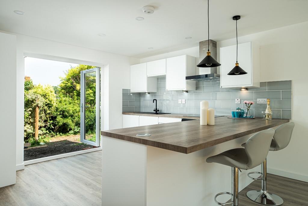 A modern and clean kitchen with ample natural l...