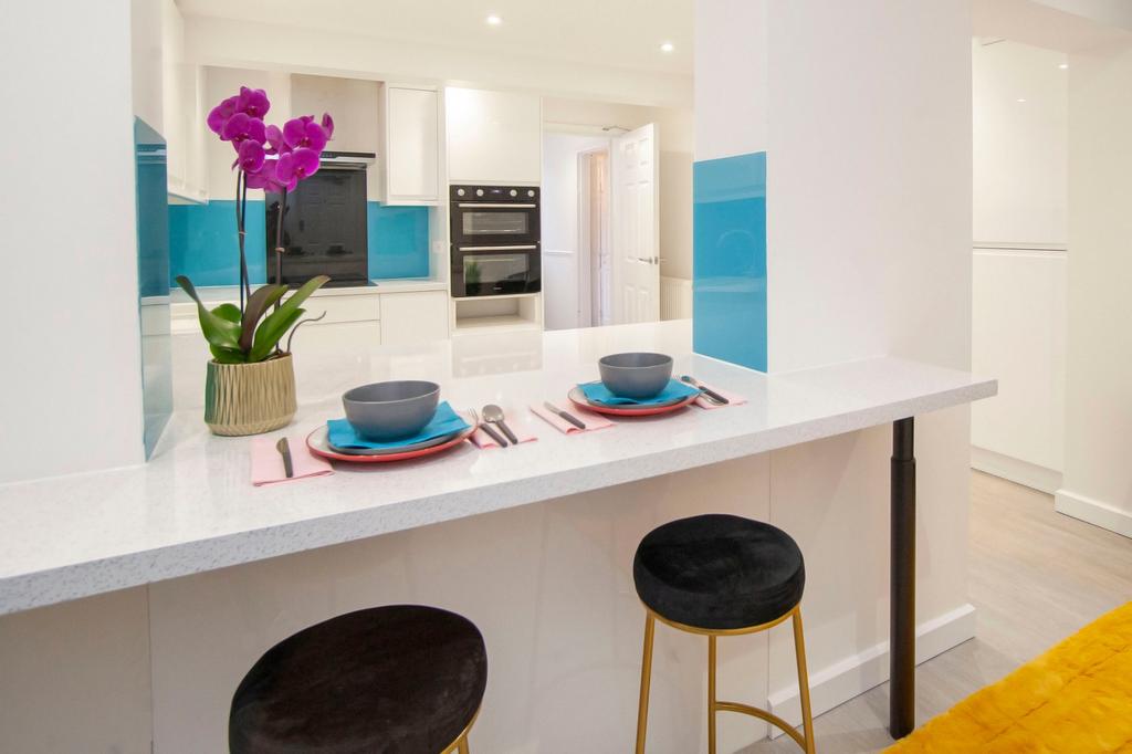 A modern and clean kitchen with a breakfast bar...