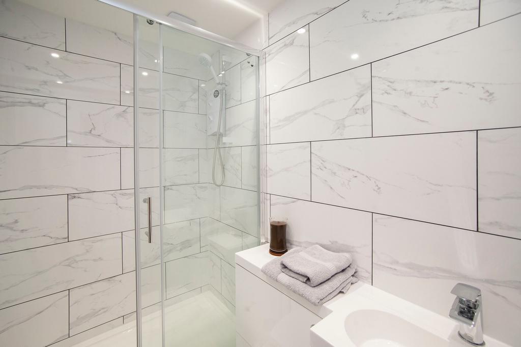 A modern and clean bathroom featuring a shower ...