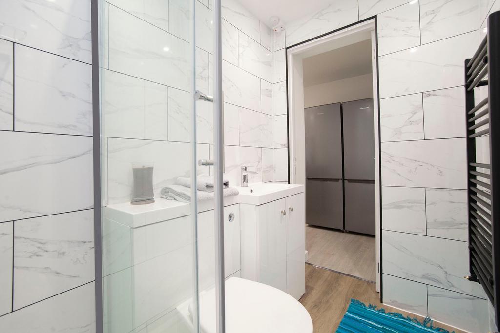 A modern and clean bathroom featuring a glass s...