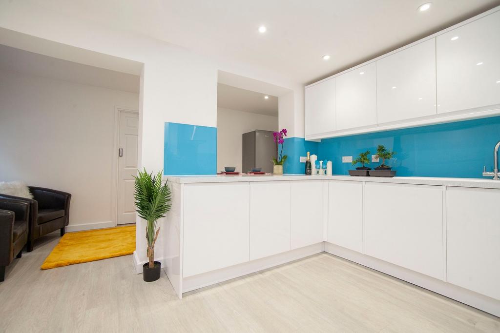 A modern and clean kitchen with bright blue acc...