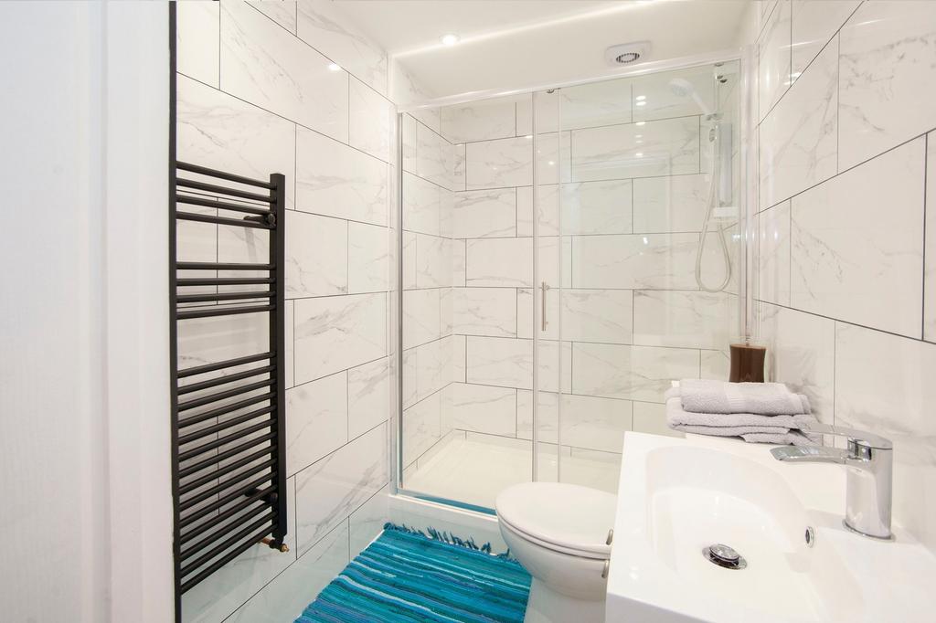 A modern and clean bathroom with a shower, feat...