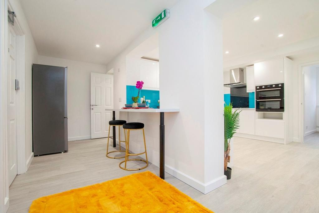 A modern and tidy kitchen with bright lighting ...