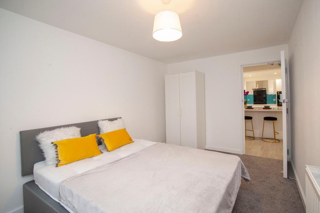 A clean and well-lit double bedroom featuring a...