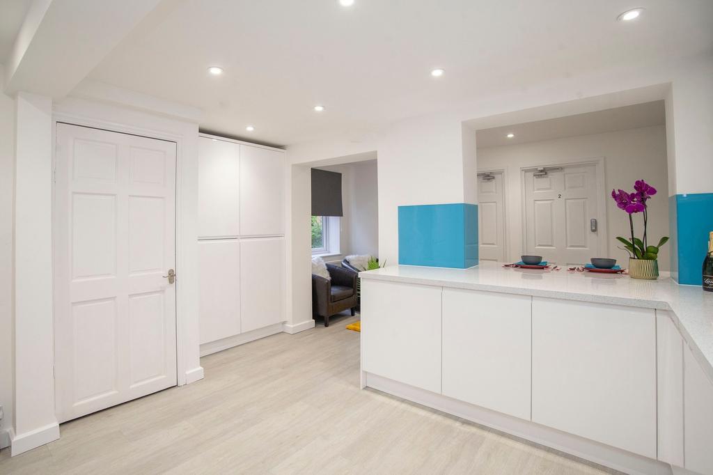 A modern kitchen with bright lighting and clean...