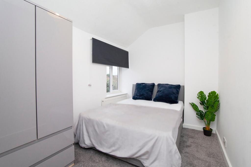 A clean and well-lit double bedroom featuring a...