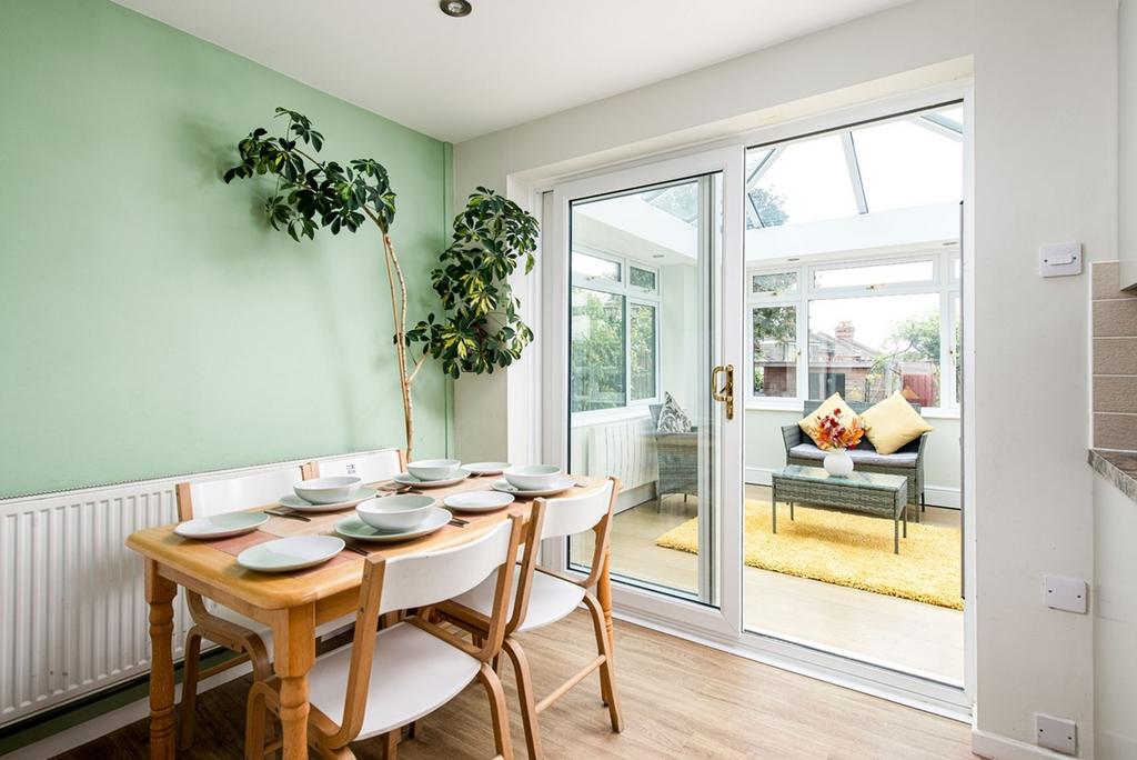 A bright and clean kitchen area with a dining t...