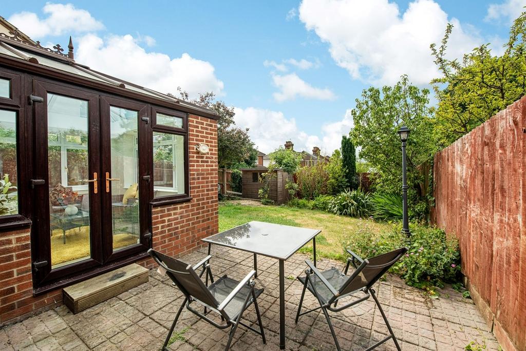 A well-maintained garden with a patio table and...