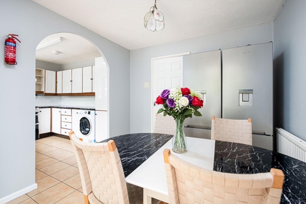 A bright and tidy kitchen featuring a dining ta...