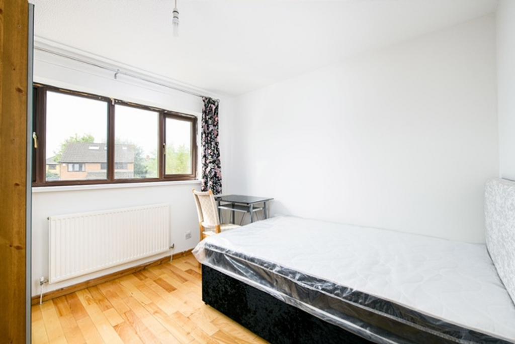 A bright and clean double bedroom with a large ...