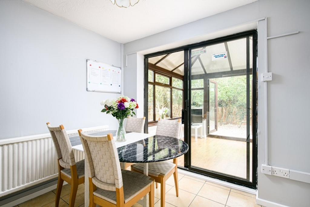 A modern kitchen area with a dining table and l...