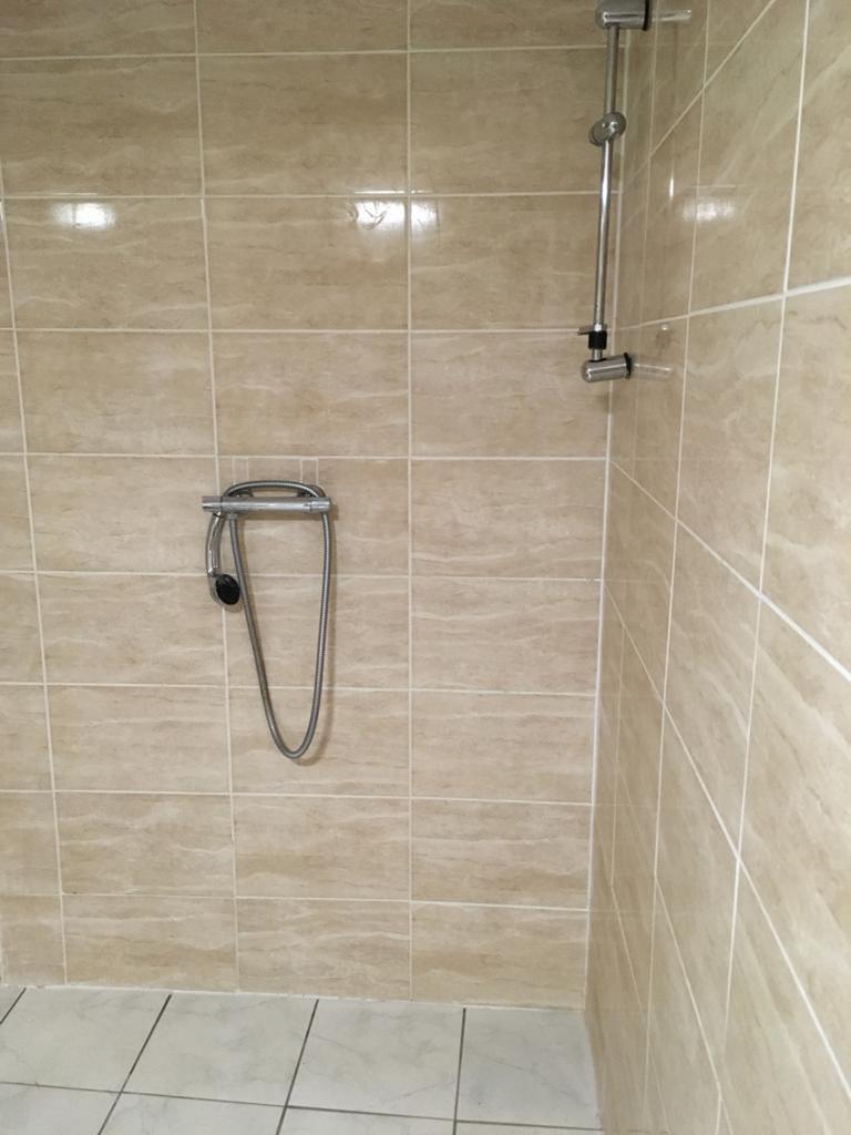 A clean and modern bathroom featuring a shower ...