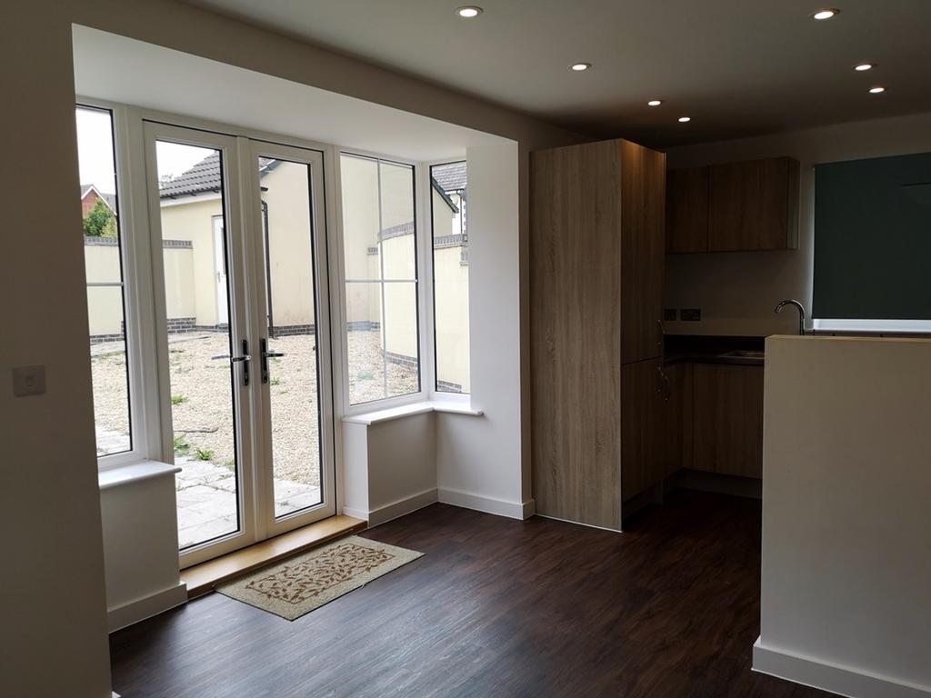 A modern and well lit kitchen with ample space ...