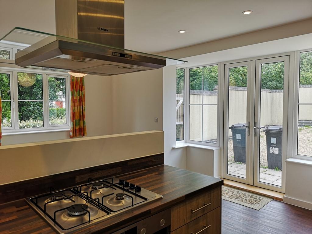 A spacious and modern kitchen with ample natura...