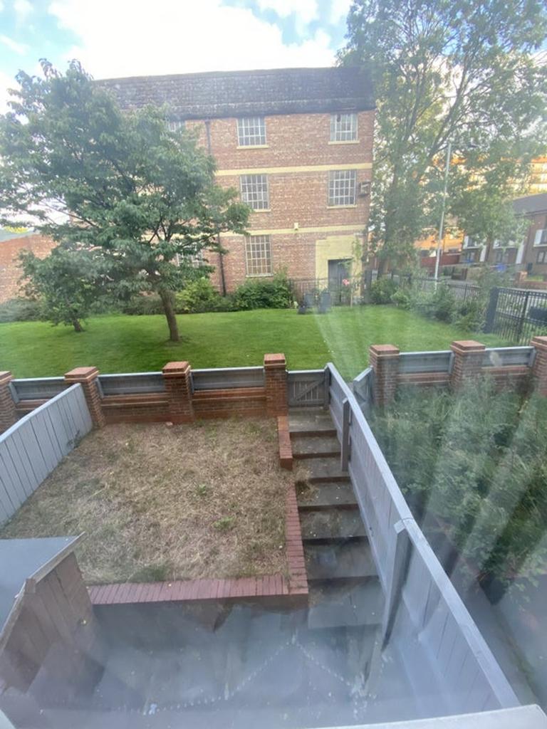 A spacious garden area with well-maintained gra...