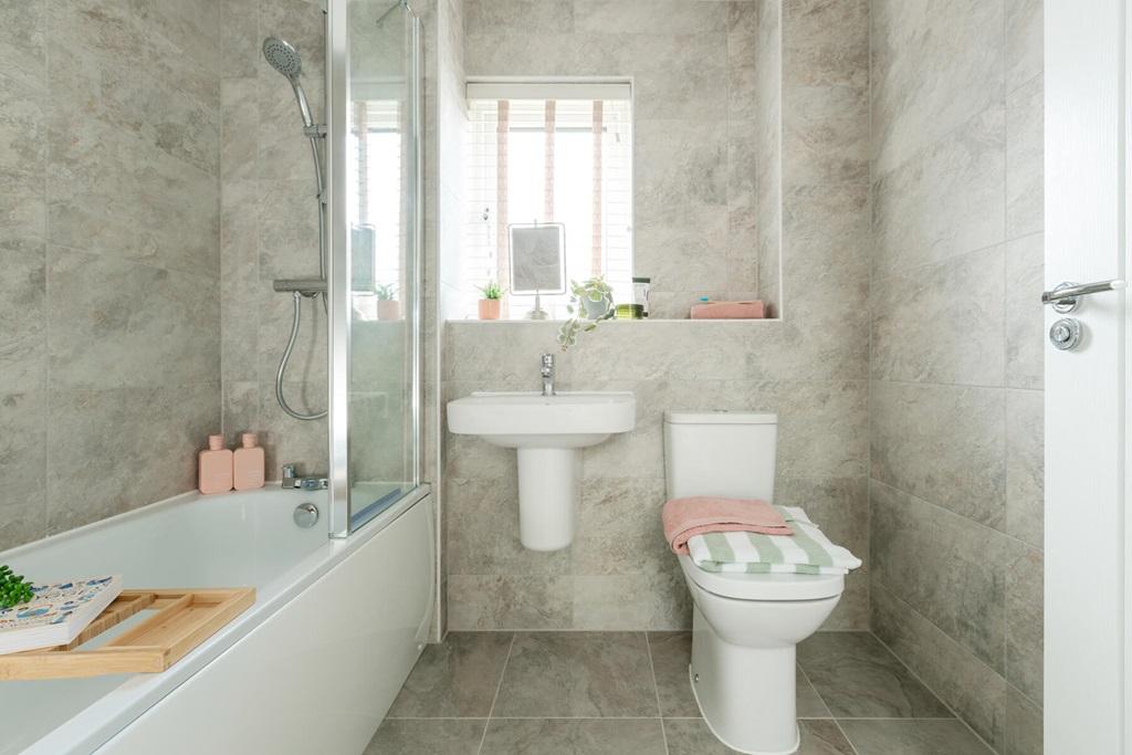 Stylish bathroom with shower over bath