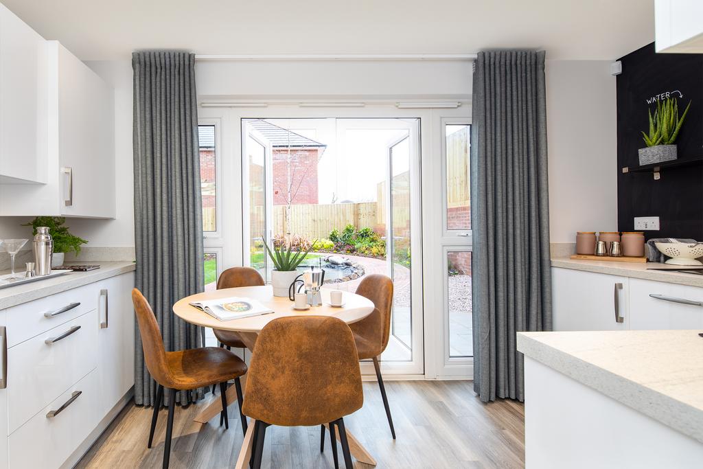 Kitchen with dining area and French doors in...