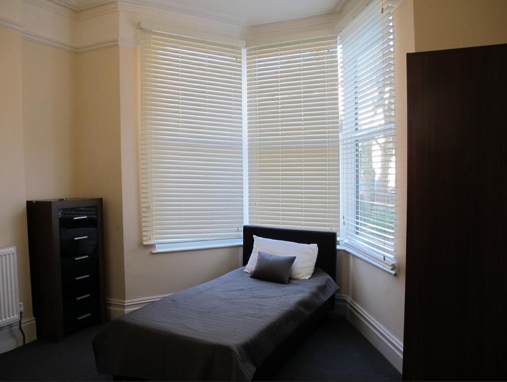 A bright and tidy single bedroom with ample nat...