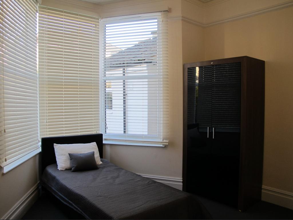 A bright and tidy single bedroom with ample nat...