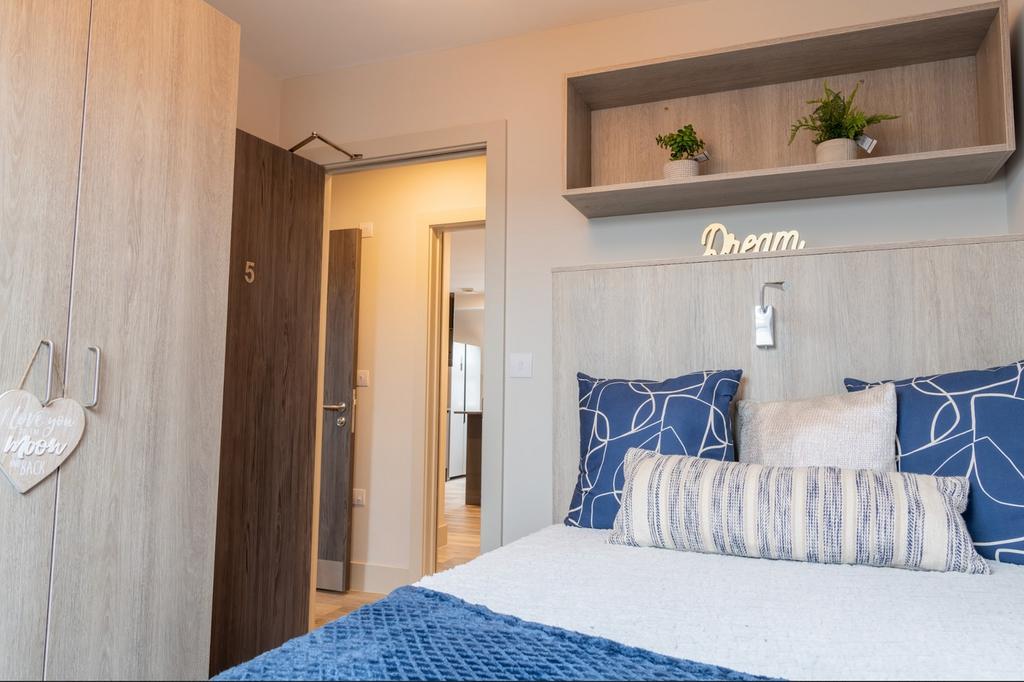 A bright and inviting double bedroom featuring ...