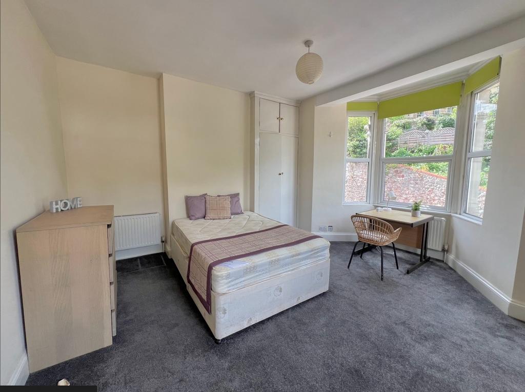 A spacious and bright double bedroom featuring ...