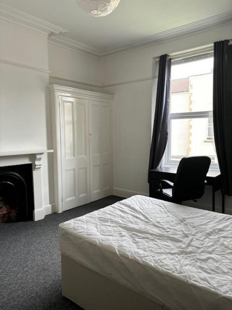 A spacious and well lit double bedroom featurin...