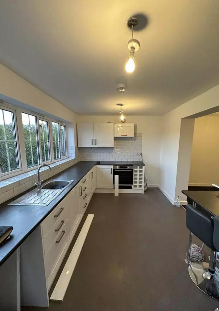 A modern and spacious kitchen with ample natura...