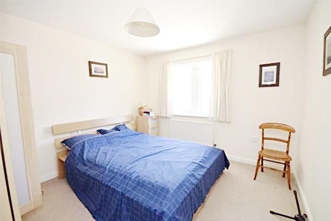 Bright, neutrally decorated double bedroom with...