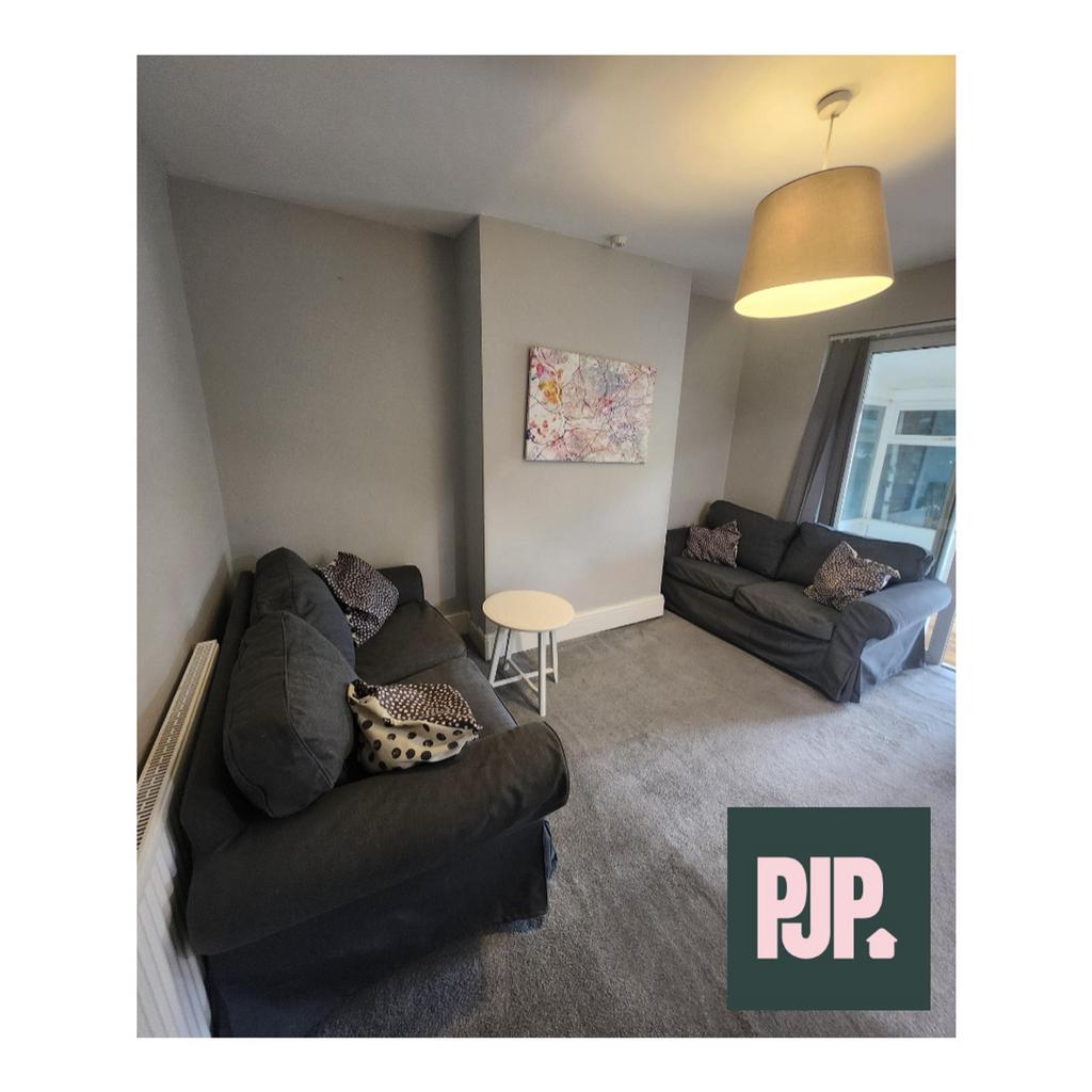 A spacious and inviting living room with comfor...