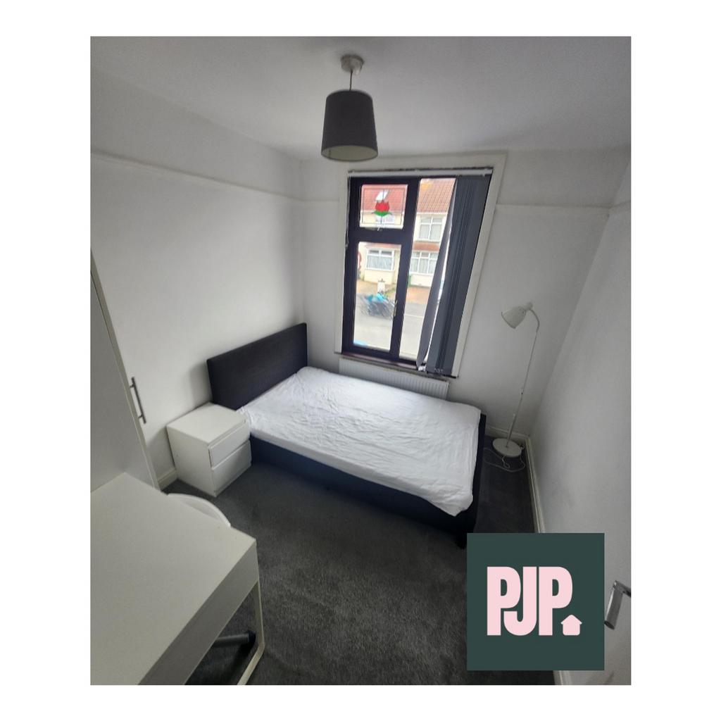 A well-lit double bedroom with ample natural li...