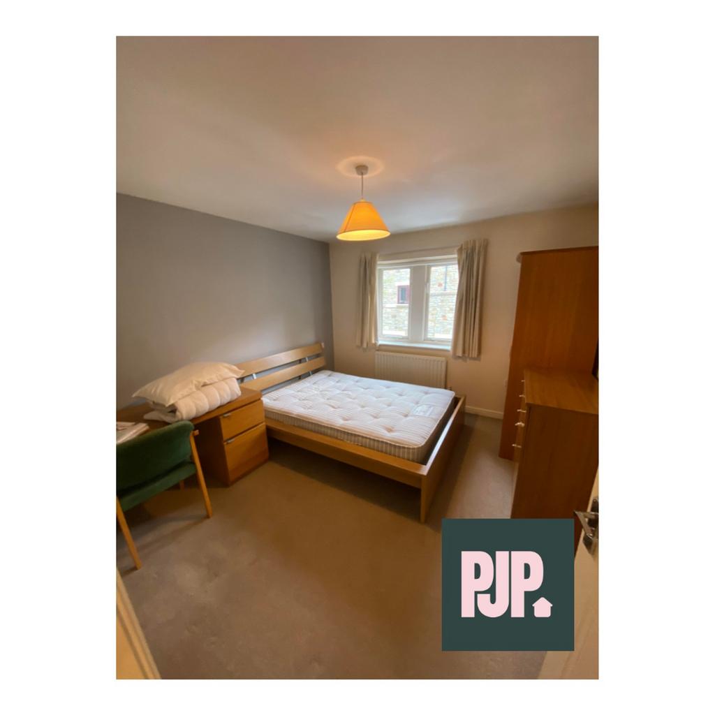 A cozy and well-lit double bedroom, perfect for...