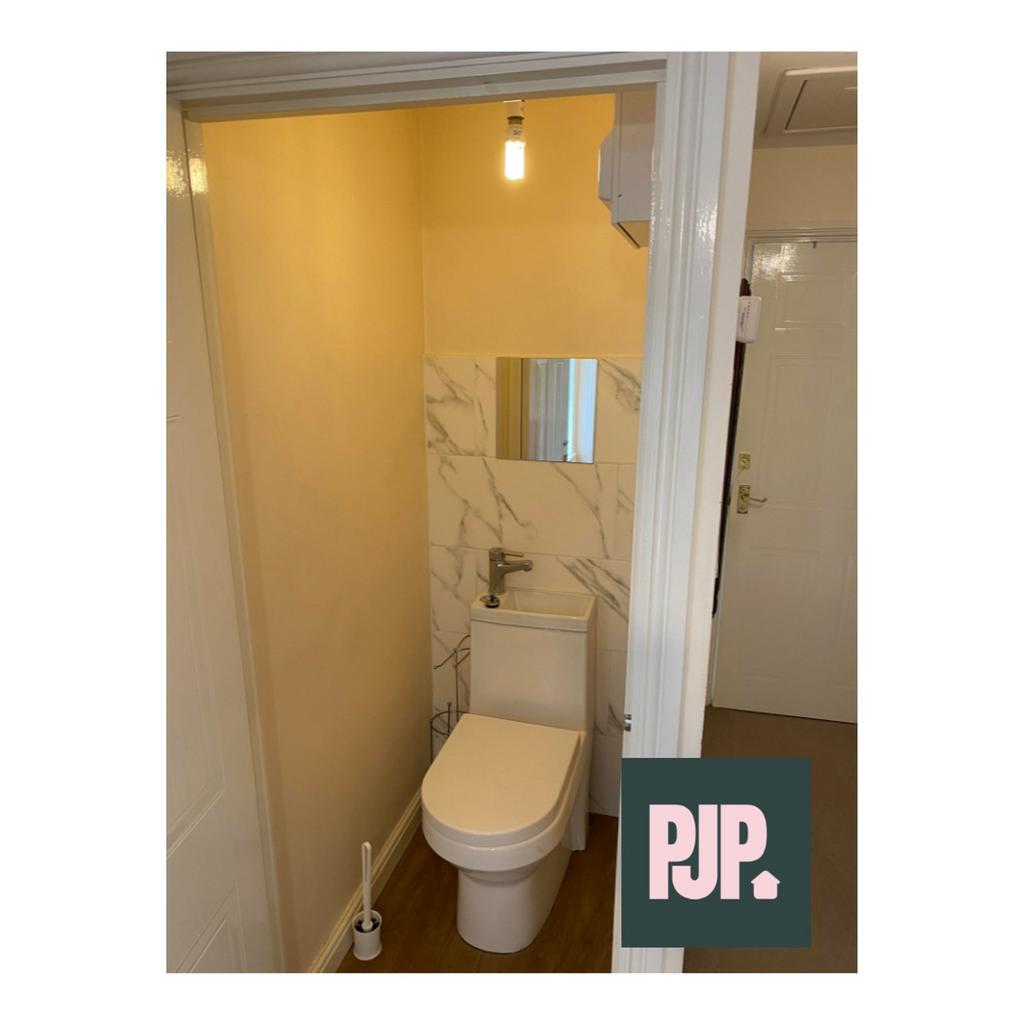 A modern and tidy single toilet with stylish fi...