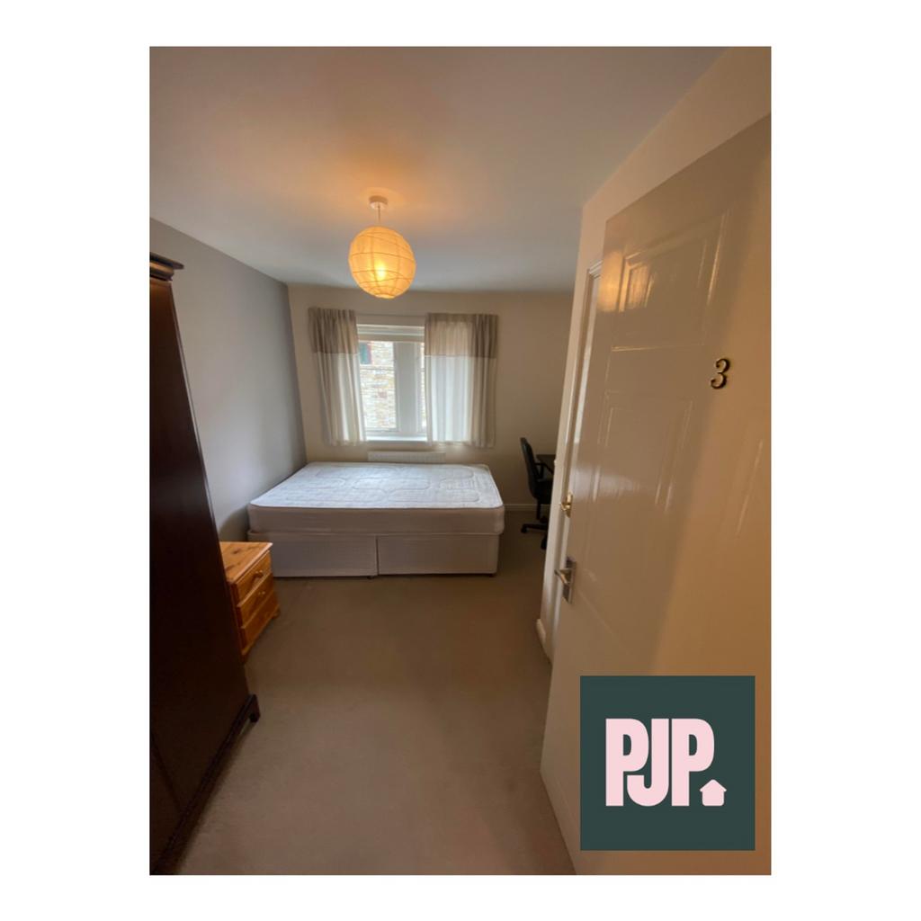 A spacious and well-lit double bedroom with a n...