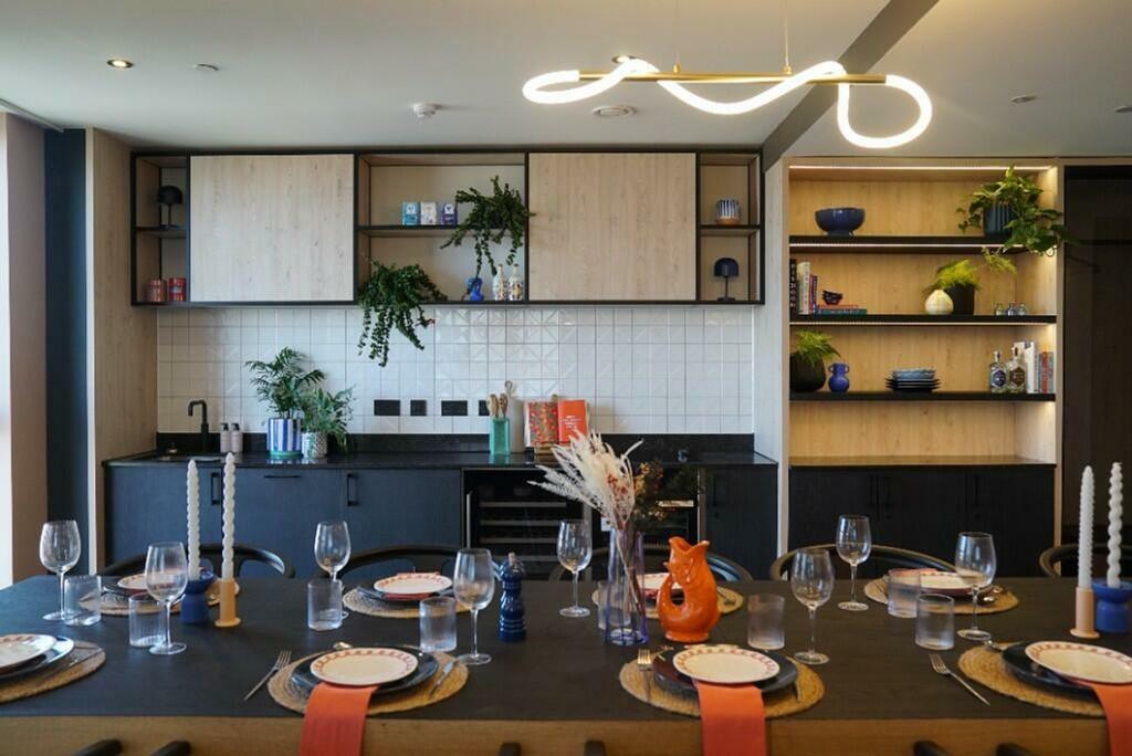 A modern, clean kitchen featuring a dining area...